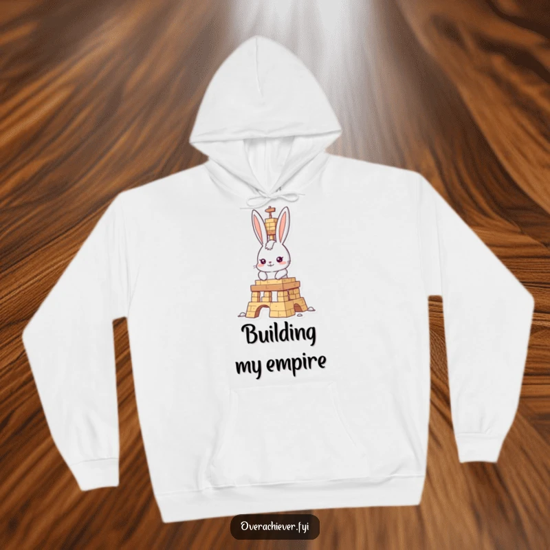 Funny rabbit builder hoodie, determined character focused on building an impressive structure, offering cozy warmth and a humorous design.
