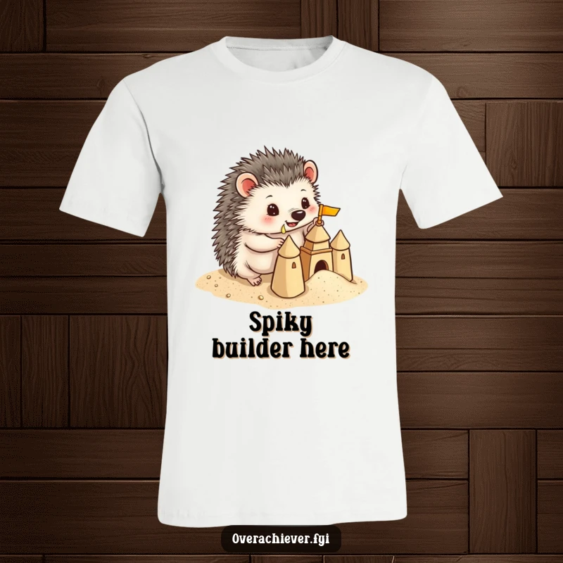 Funny Hedgehog T-Shirt: A playful hedgehog building a miniature sandcastle with precise detail, highlighting its creative and comical nature.