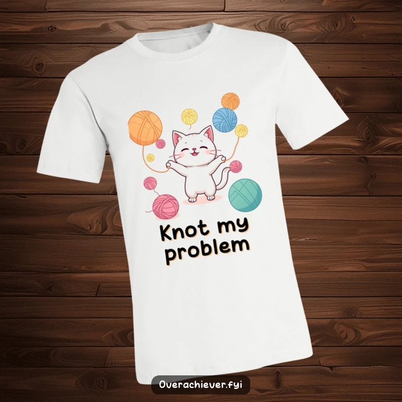Funny t-shirt with a Kawaii cat character juggling an overwhelming number of yarn balls, capturing playful yet chaotic energy.
