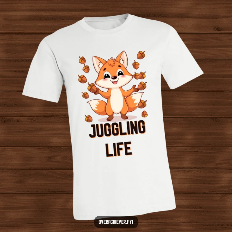 Funny t-shirt featuring a playful fox character grinning while juggling an impossible number of shiny acorns, a humorous design for the agile.